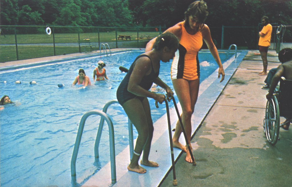 color photograph of two women by pool disability history america