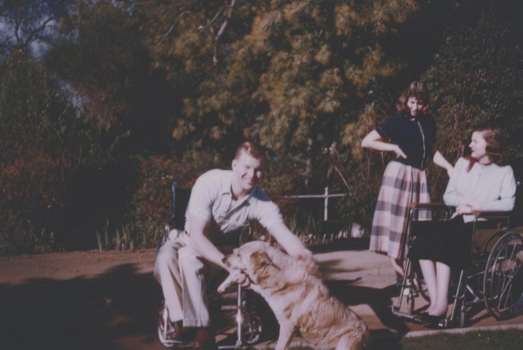 man with golden retriever color photograph disability history america