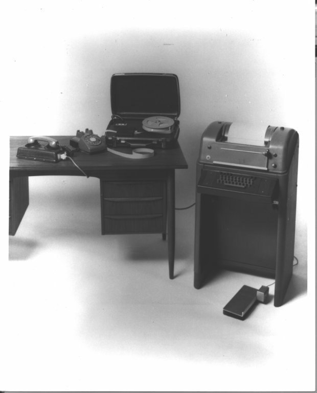 t t y on desk adjacent to braille converter black white photograph disability history america