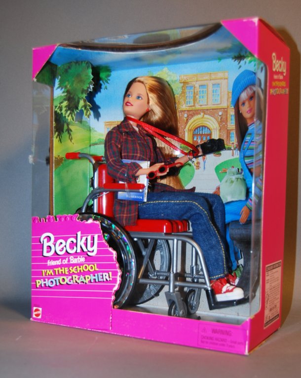 A Wheelchair Becky doll in original packaging.