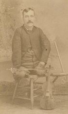 adult male violinist seated sepia photograph disability history america