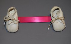 pair of shoes connected by pink device disability history america